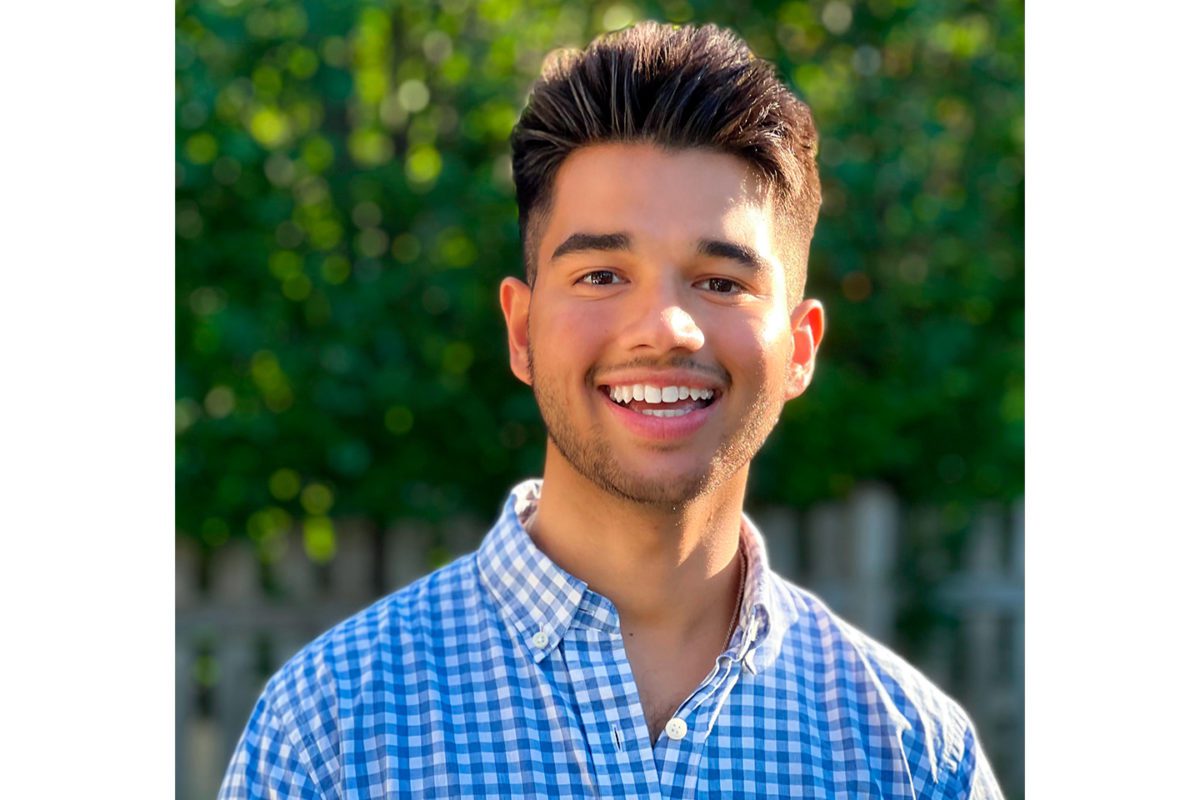 A headshot of John Jayasankar standing outside.