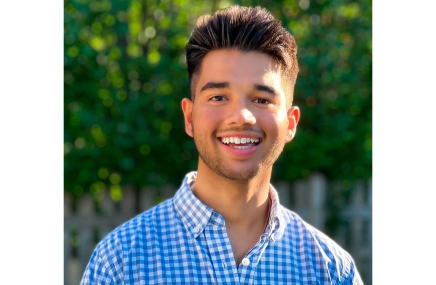 A headshot of John Jayasankar standing outside.