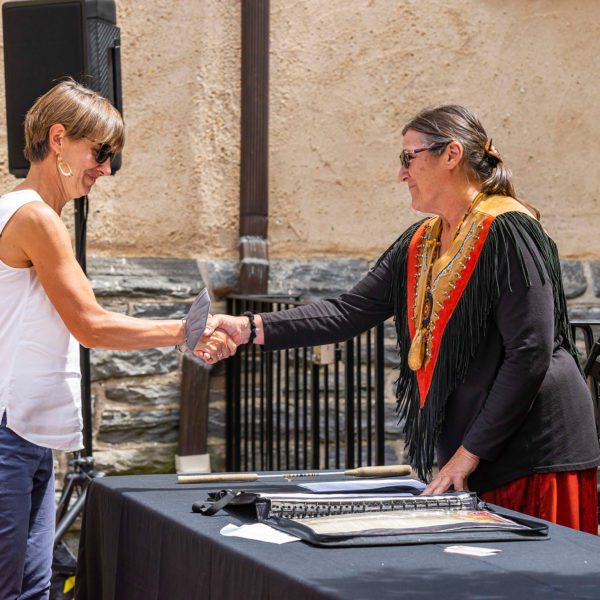 Calista Cleary shakes hands with Lenape Nation of PA member Shelley DePaul over the treaty she has just signed