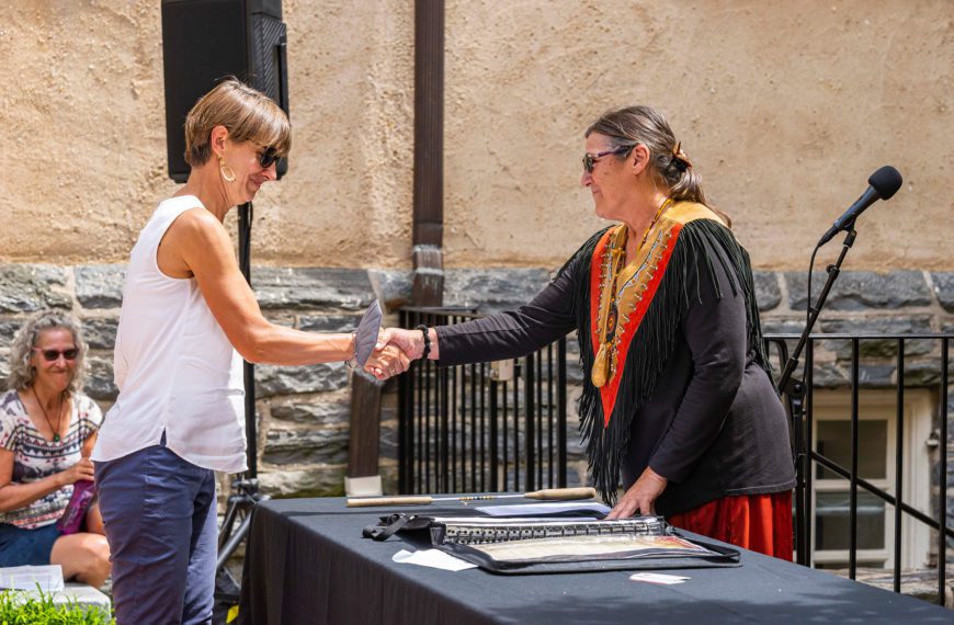 Calista Cleary shakes hands with Lenape Nation of PA member Shelley DePaul over the treaty she has just signed