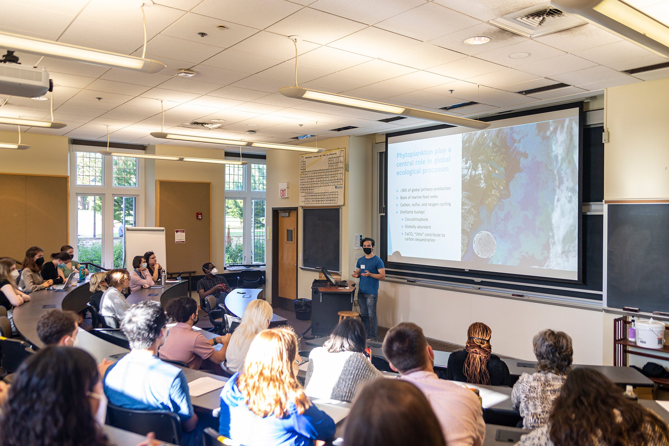 Oscar Garrett '23 stands in front of an audience, discussing his research project. Photo by Patrick Montero.