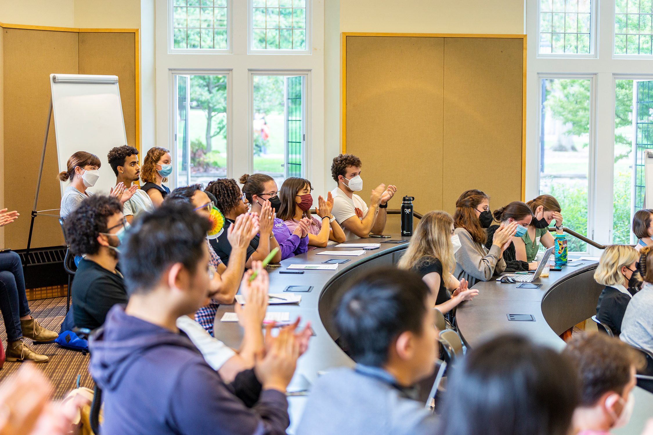 The audience applauds for a student research presentation. Photo by Patrick Montero.