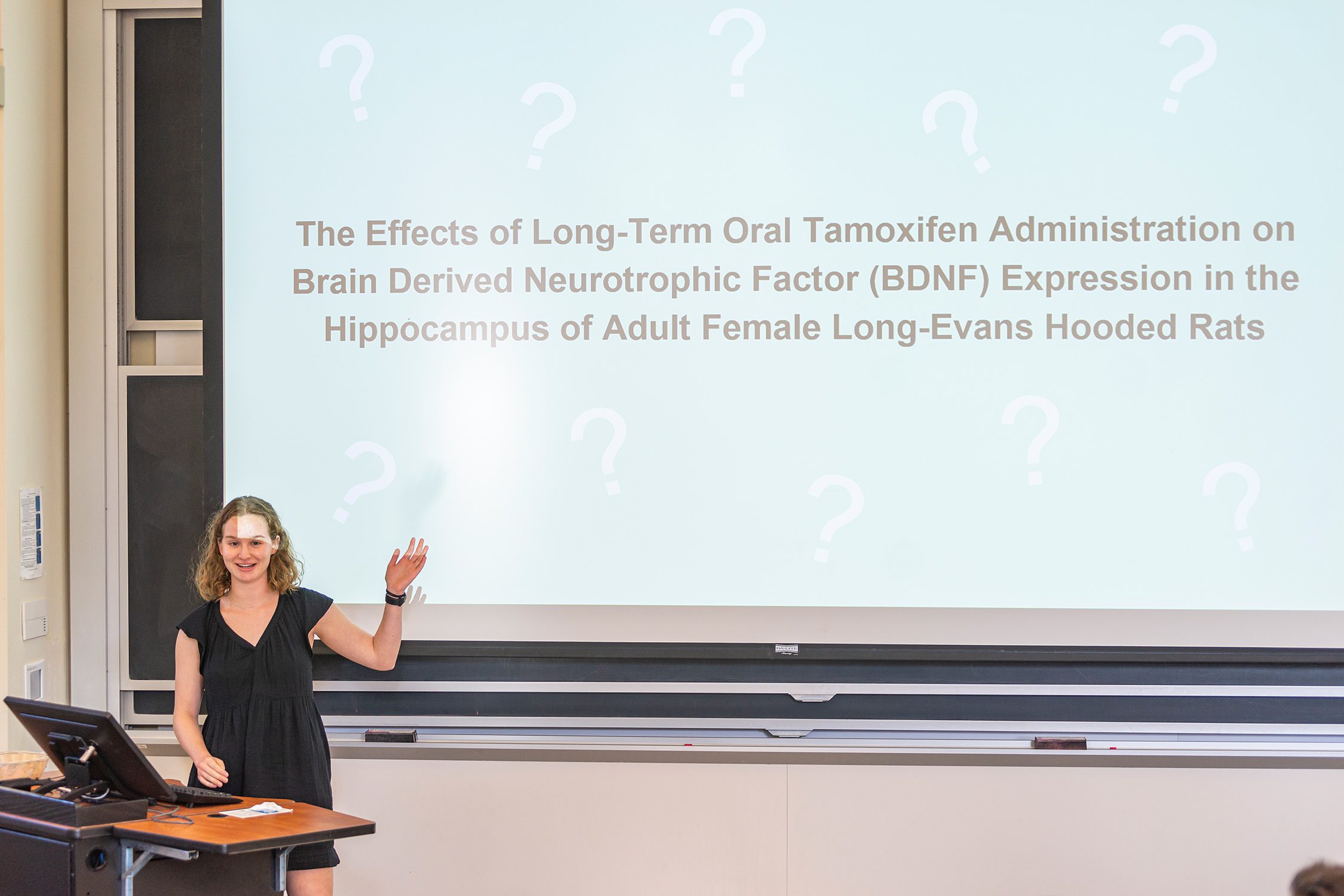 Amanda Halliday '23 stands in front of a projector, discussing her research project. Photo by Patrick Montero.
