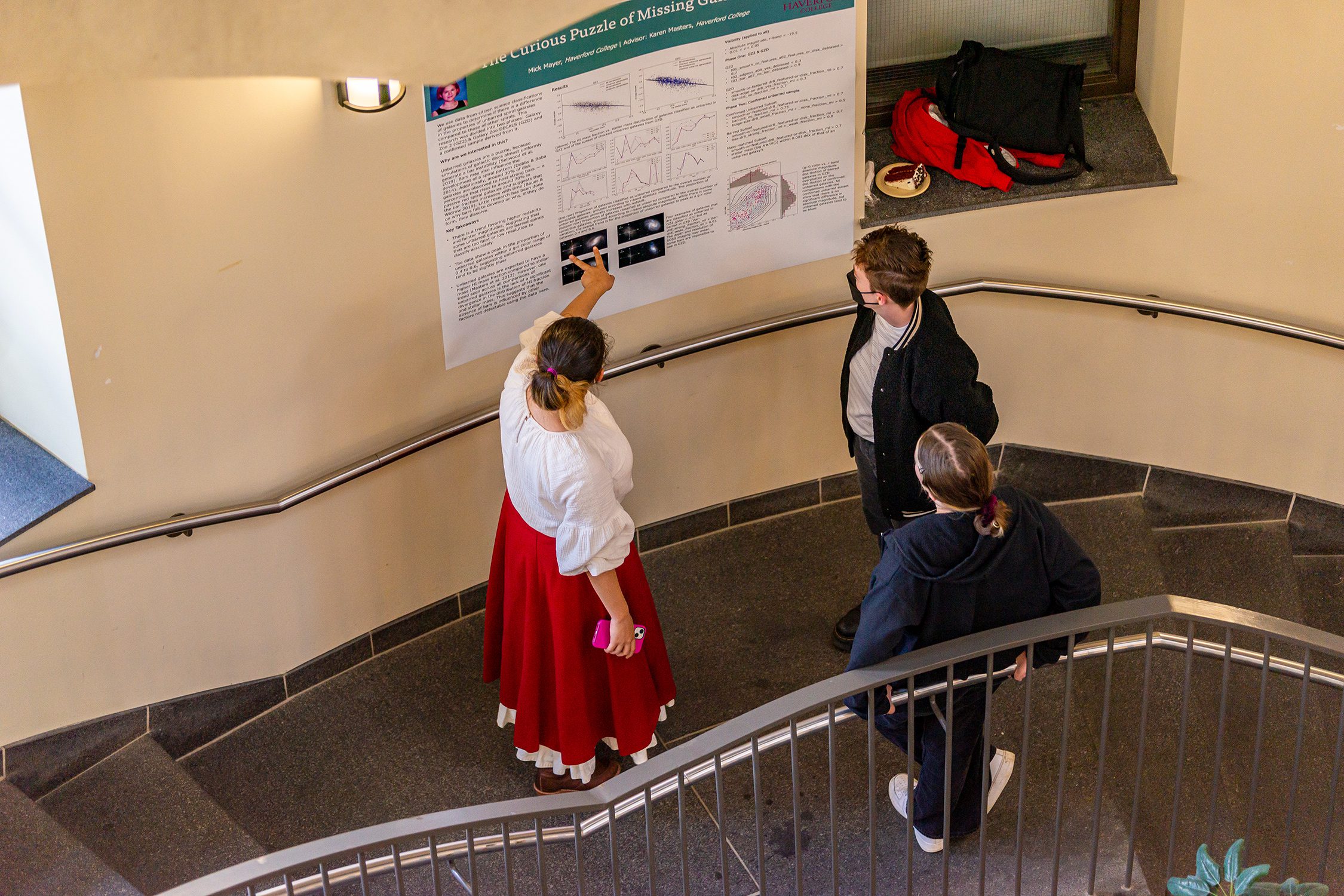Students discuss a poster in the KINSC Rotunda. Photo by Patrick Montero.