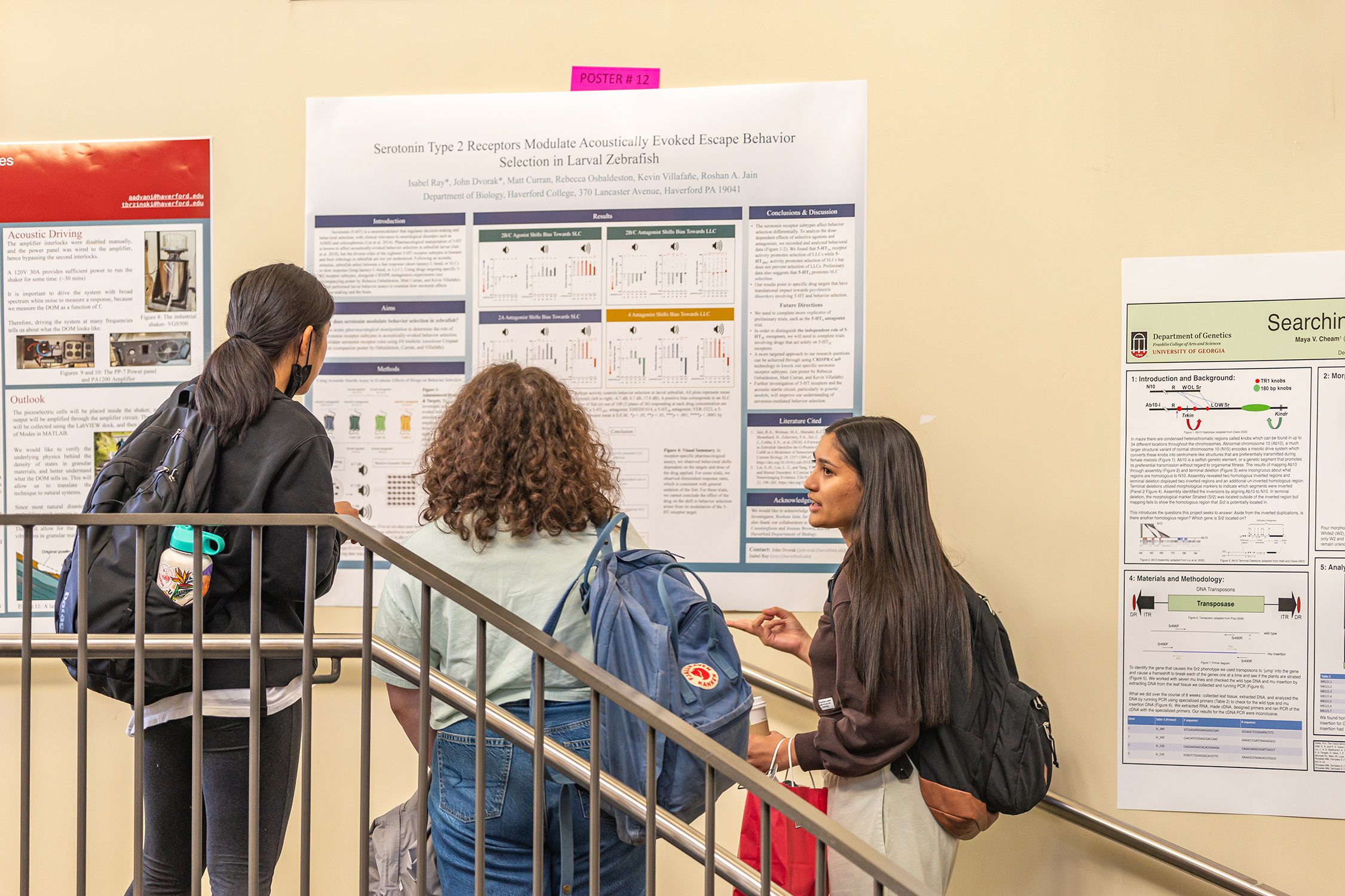 Students stand in front of a poster in the KINSC Rotunda, talking. Photo by Patrick Montero.