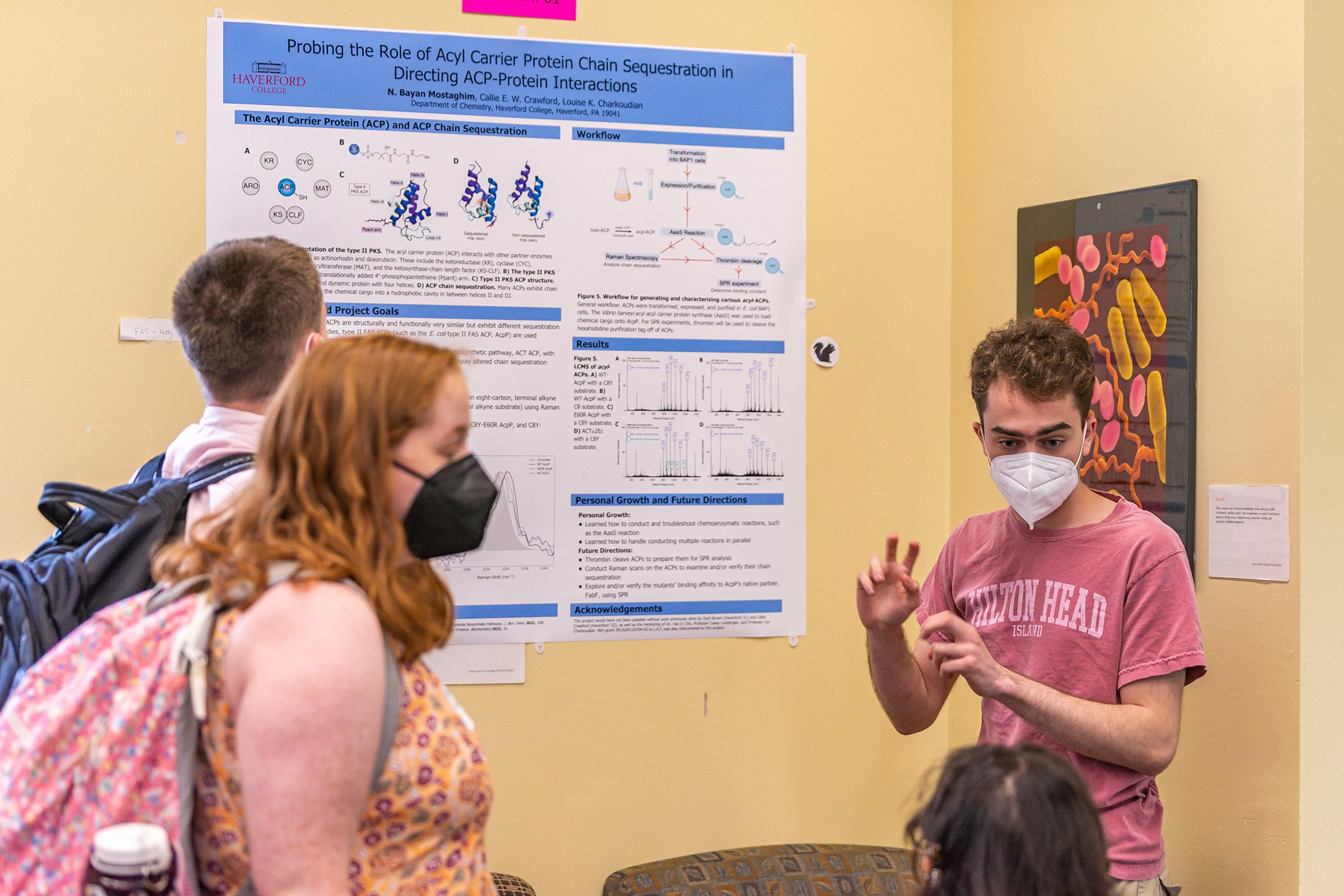 Bayan Mostaghim '23 stands in front of his poster discussing his research. Photo by Patrick Montero.
