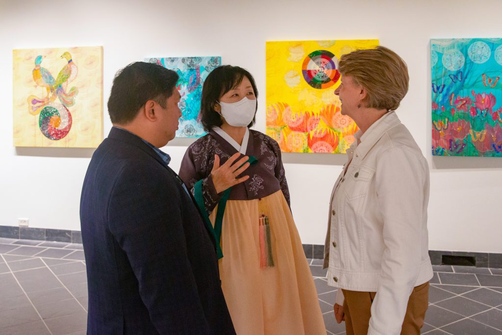 Professor Kim and Dr. Ricardo Reyes speaking with Haverford President Wendy Raymond at the exhibition opening. Photo by Alexandra Iglesia '21.
