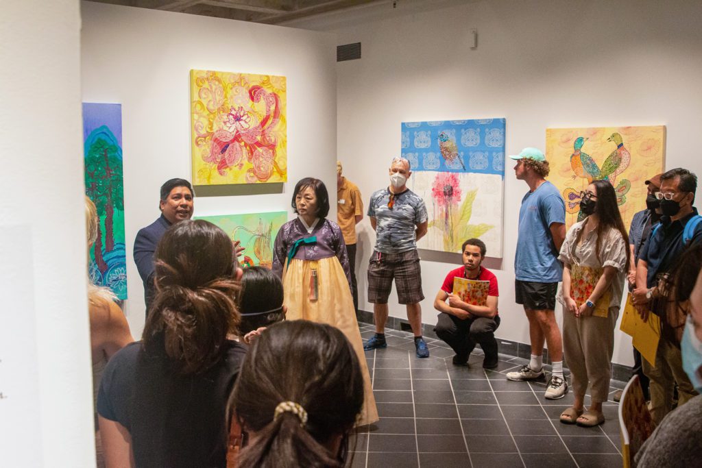 Dr. Ricardo Reyes speaking to exhibition attendees at the opening. Photo by Alexandra Iglesia '21.