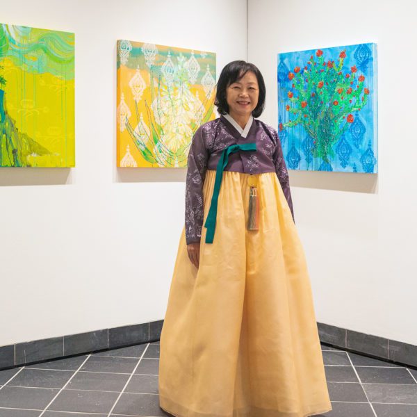Professor Hee Sook Kim at the exhibition opening in a hanbok.