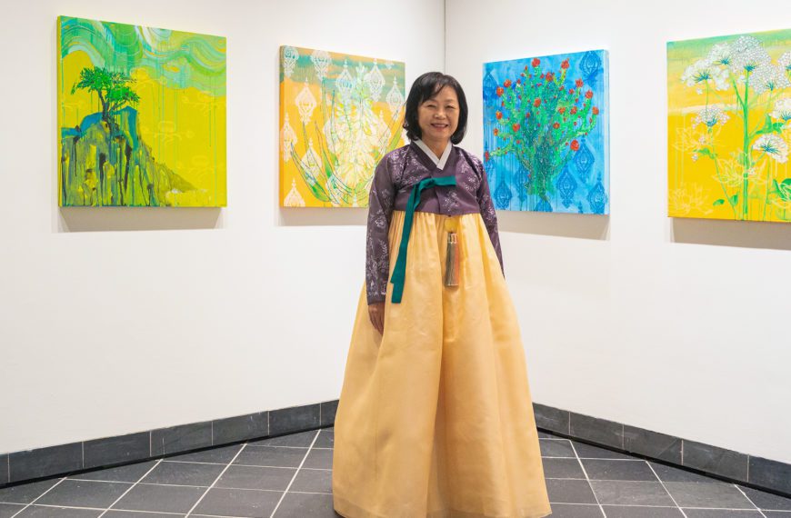 Professor Hee Sook Kim at the exhibition opening in a hanbok.