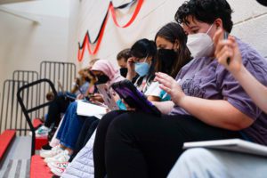 Students voting on their devices on whether or not to pass a resolution. Photo by Abigail Trapp '26.
