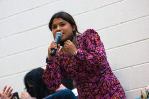 A student speaks into a microphone during a debate session. Photo by Abigail Trapp '26.