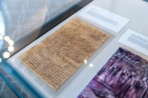 An 18th century letter and a copy of Ghost River: The Fall and Rise of the Conestoga lie as part of "In Perpetuity." Photo by Patrick Montero.