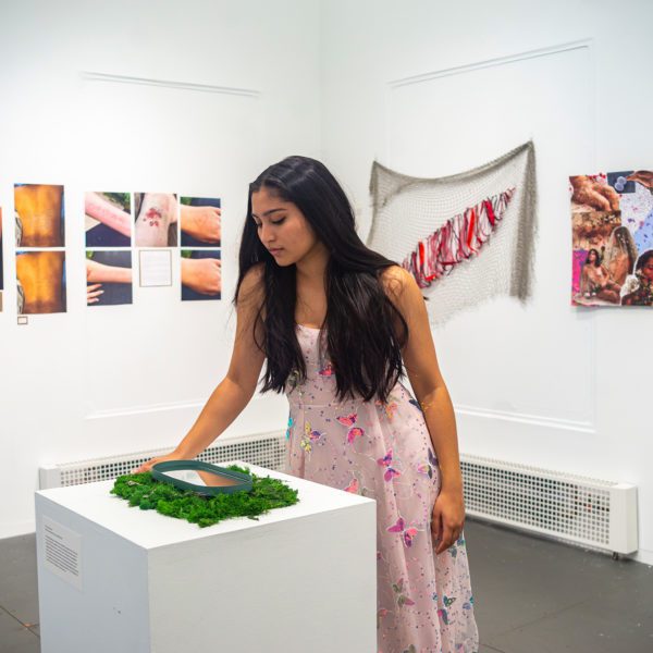 Izzy Ray '23 looking at her reflection in her "Pool of Narcissus."