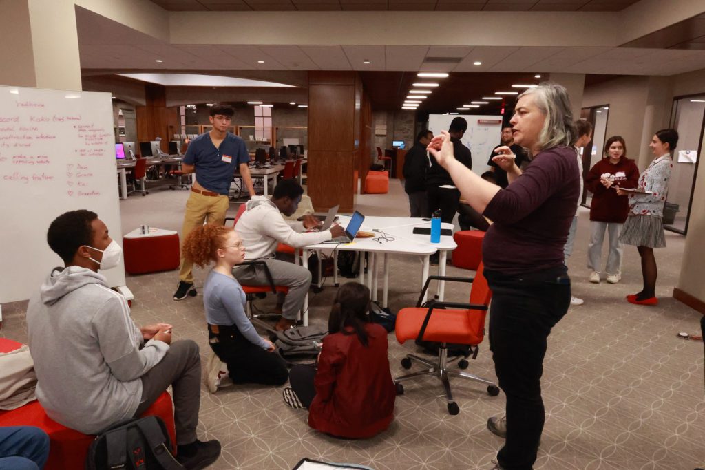 Shayna Nickel speaks to a group of students about a project. Photo by Ella Mbanefo '26