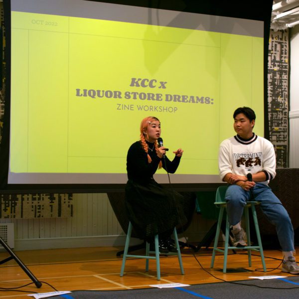 Director So Yun Um (left) sitting with Yehyon Song '25 in front of a projector at the "So, Let's Talk About It" event as part of the Strange Truth series.