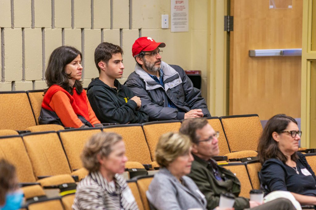 Students and their families listen intently to the career discovery panel.