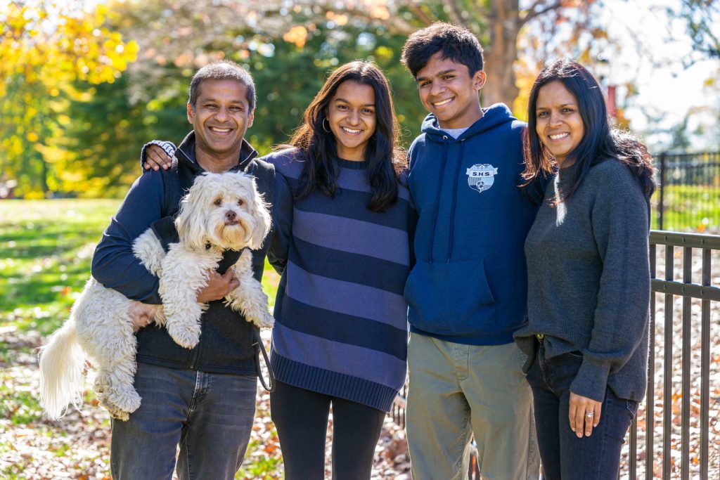 An outdoor fall family portrait including the family dog