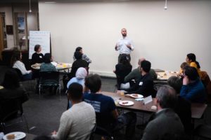 Andres Mauricio Celin '11, a community organizer and consultant, addressing the group.