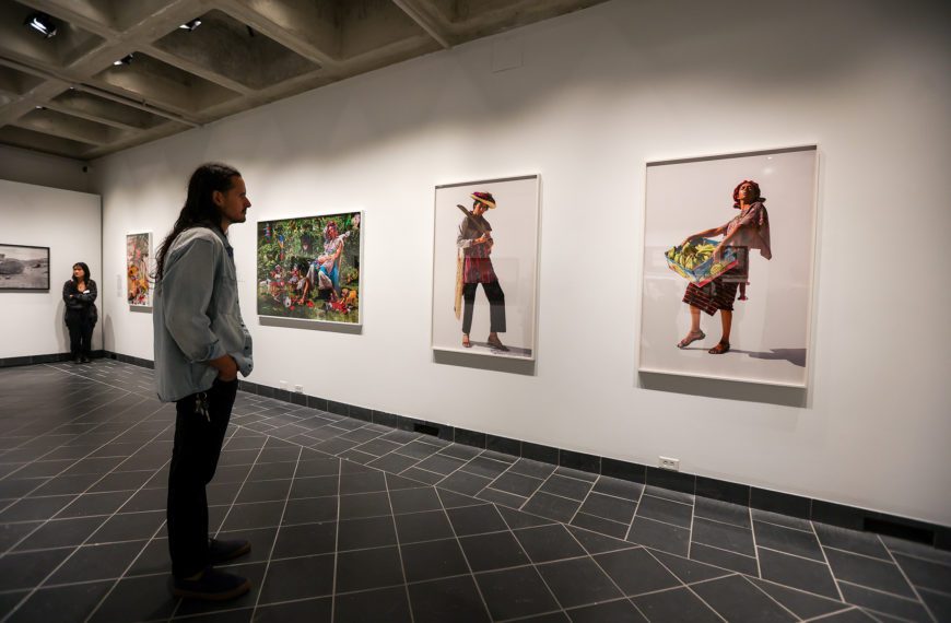 A patron looks at photos in "Native America: In Translation," located in the Cantor Fitzgerald Gallery. Photo by Paola Nogueras.