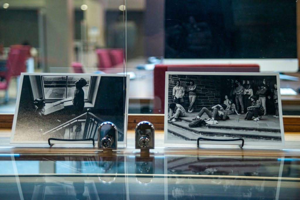 Photos of pictures displayed in the exhibit, including a student studying in a Barclay windowsill and students sitting outside the Dining Center. Photo by Patrick Montero.