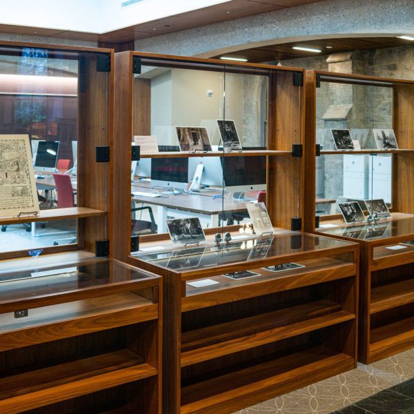 A picture of library display cases, where the exhibit "The Spaces Between" is on display. Photo by Patrick Montero.
