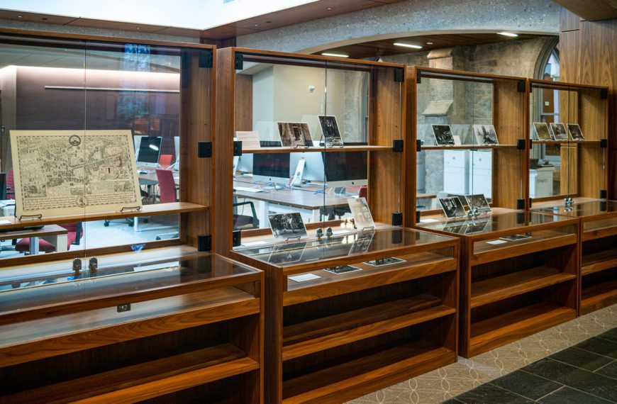 A picture of library display cases, where the exhibit "The Spaces Between" is on display. Photo by Patrick Montero.