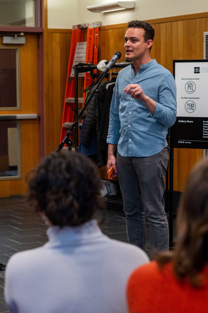 Artist Mark Menjívar speaking outside of the gallery at the exhibition opening. Photo by Logan de Raspide Ross '23.