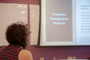 A participant listens during "Undocumented in US Higher Education." Photo by Anna Braun '26.