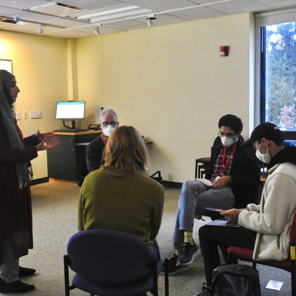 Participants sit in a semi-circle at a breakout session and listen to a presenter. Photo by Abigail Trapp '26.