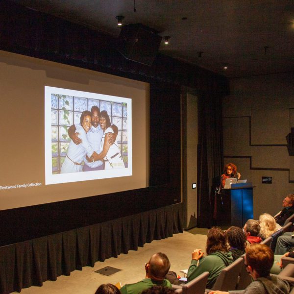 Nicole Fleetwood stands at the front of an auditorium, delivering her keynote address. Photo by Iris Saada '25.