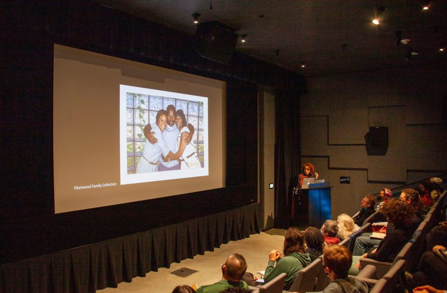Nicole Fleetwood stands at the front of an auditorium, delivering her keynote address. Photo by Iris Saada '25.