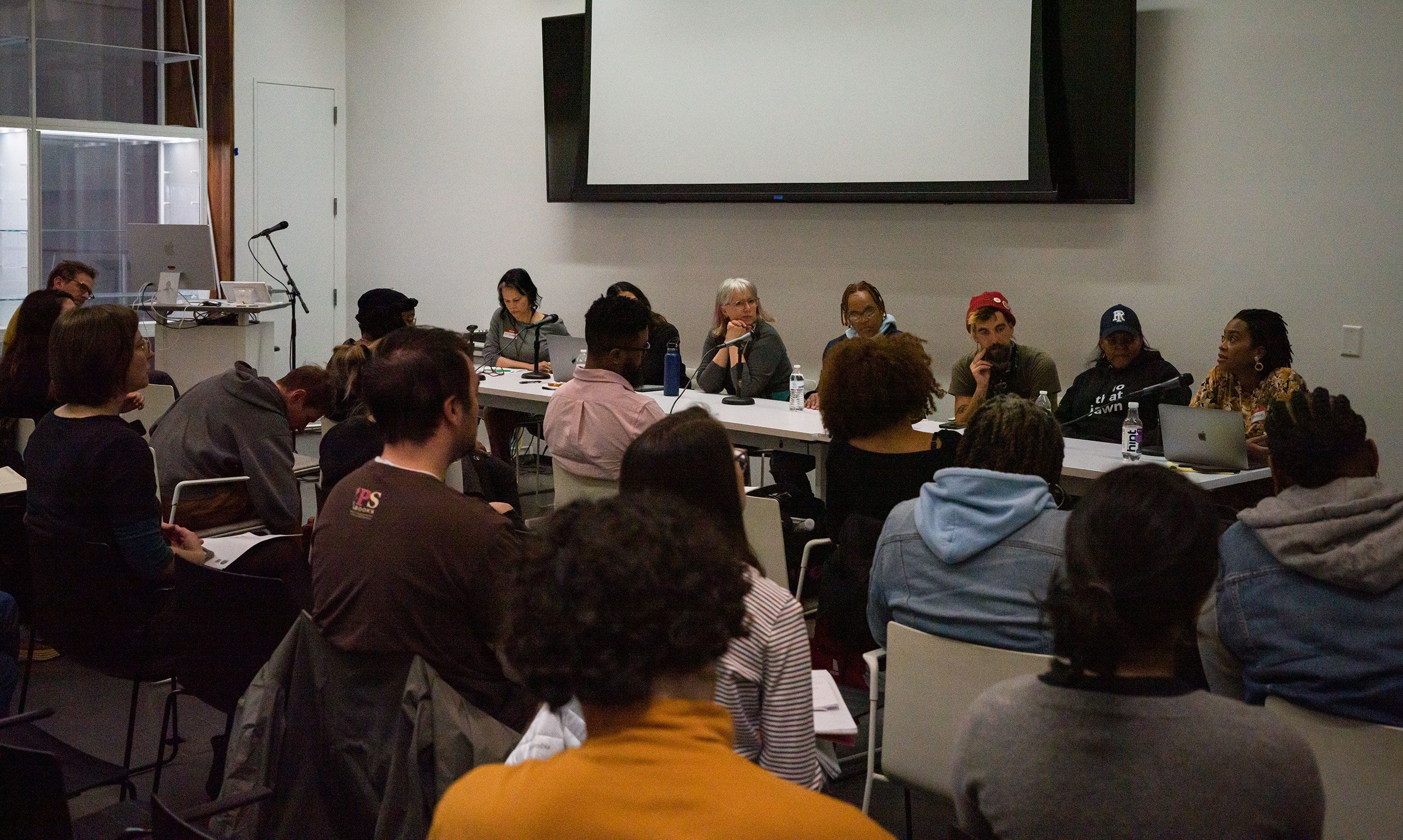 Panelists discuss at the front of a room. Photo by Maggie Zhang '24.