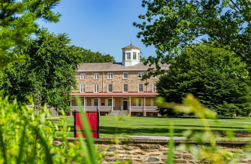 View of Founder's Hall on a nice day through the greenery