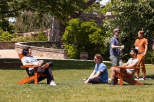 group of alumni gathered in chairs on Founder's Green