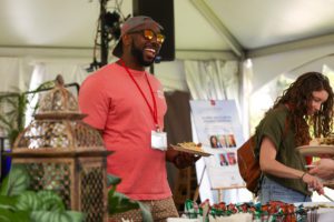 man smiling while in line for food at Alumni Lunch