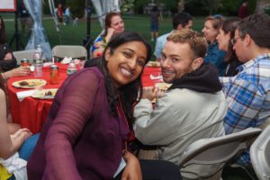 two people smiling for a photo during dinner