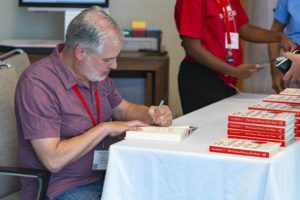 Vince Figueredo '83 signing a copy of his newly published book The Curious History of the Heart: A Cultural and Scientific Journey