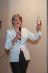 President Wendy Raymond giving a champagne toast