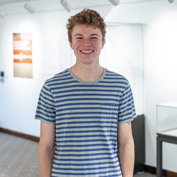Portrait of Nicholas Lasinsky '23, curator of The Hundred Tongues of Rumour exhibition on display in the Rebecca and Rick White Gallery. Photo by Patrick Montero