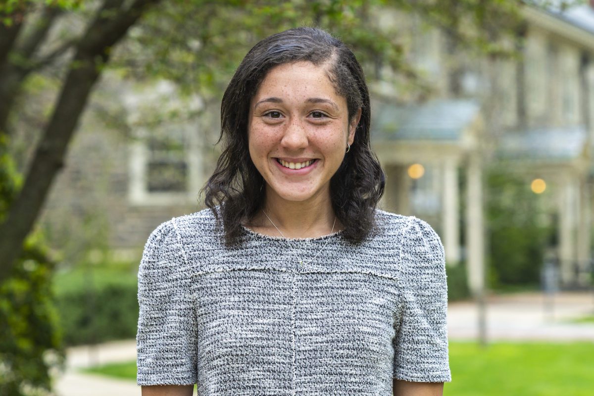 Headshot of Celia smiling outdoors.