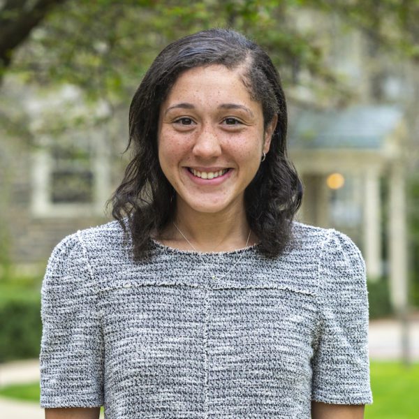 Headshot of Celia smiling outdoors.