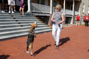 President Wendy Raymond and her dog Peanut at Founder's Hall_photo by Paola Norgueras