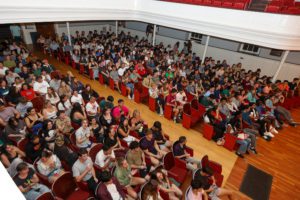 Overhead view of students watching hypnotist show_photo by Paola Nogueras