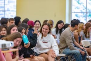 Two students high five during panel workshop_photo by Patrick Montero