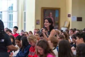Student speaking with microphone in a crowd_photo by Patrick Montero