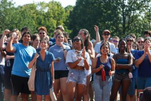 Group of students in blue cheering_photo by Paola Nogueras