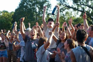 Students in gray shirts cheering after winning 2023 Dorm Olympics_photo by Paola Nogueras