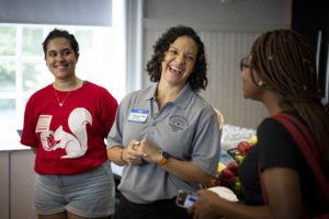 Three women standing and laughing together_photo by Dan Z. Johnson