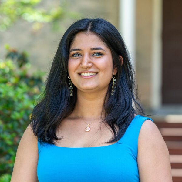 Bela Khanna wears a blue outfit and is pictured against one of Haverford's historic buildings.